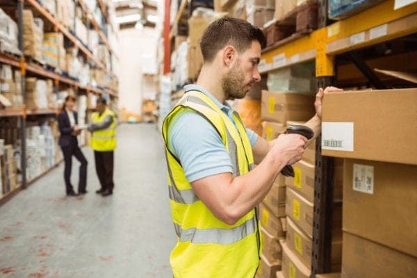 Warehouse worker scanning a barcode on a package